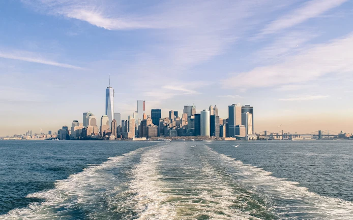New York City skyline from Statue of Liberty Ellis Island sunset cruise.