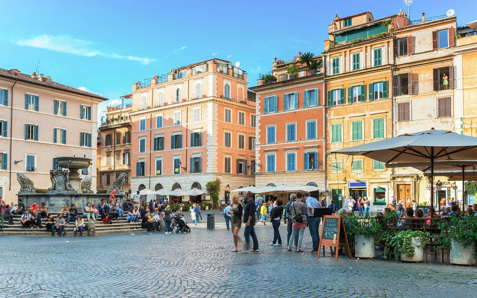 People enjoying the lively atmosphere at Square Santa Maria in Trastevere, Rome, Italy.