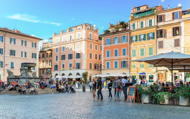People enjoying the lively atmosphere at Square Santa Maria in Trastevere, Rome, Italy.