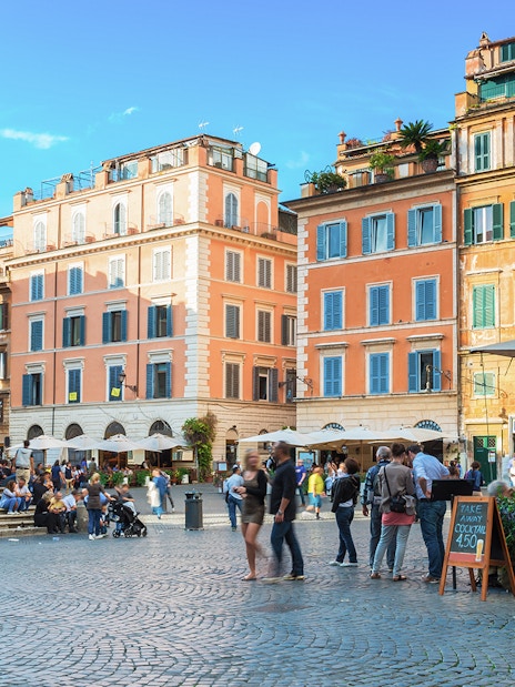 People enjoying the lively atmosphere at Square Santa Maria in Trastevere, Rome, Italy.