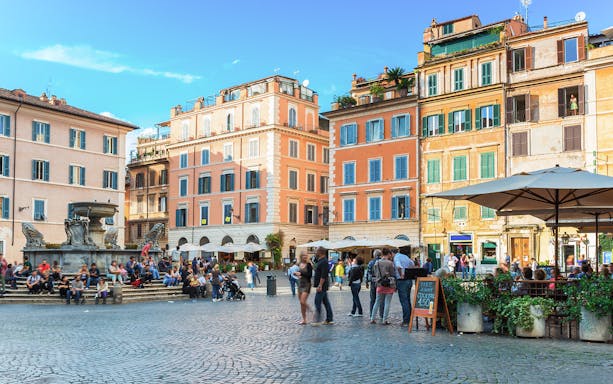 People enjoying the lively atmosphere at Square Santa Maria in Trastevere, Rome, Italy.
