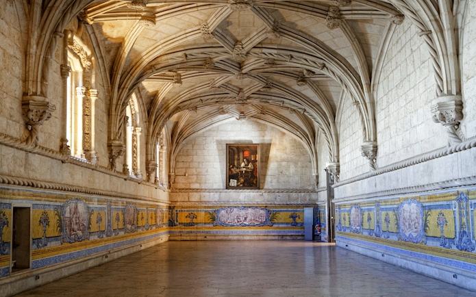 Jerónimos Monastery interior with vaulted ceilings and azulejo tiles, Lisbon, Portugal.