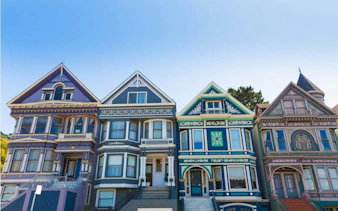 Colorful Victorian houses in Haight Ashbury, San Francisco, highlighting hippie culture.