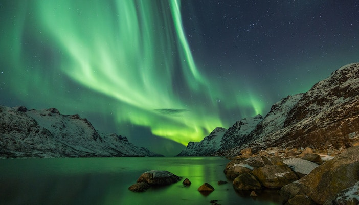 Aurora Borealis reflected between two fjords in Tromso