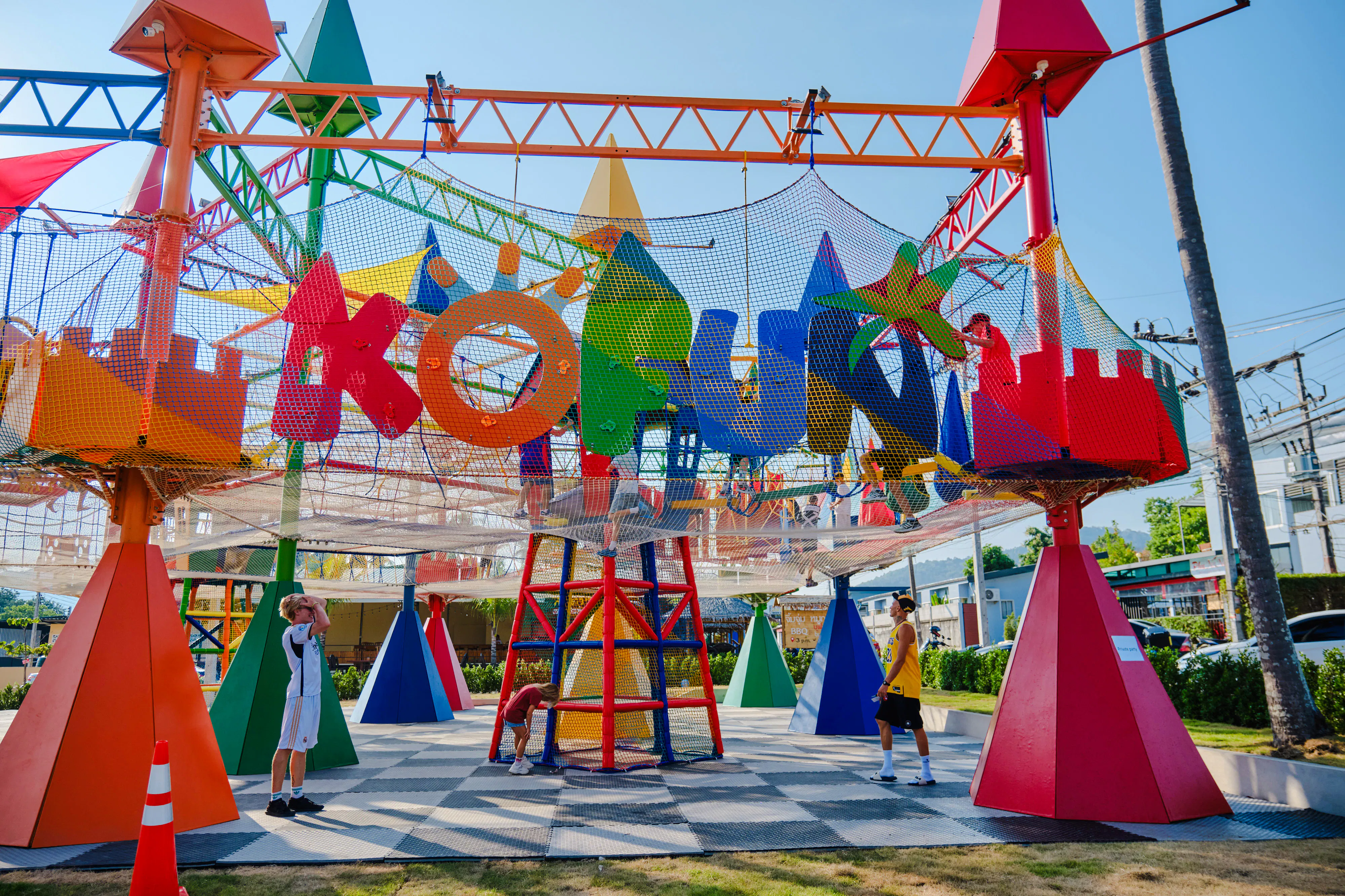 Children playing in a colorful outdoor playground in Phuket during a 3-hour birthday party.