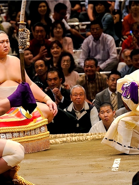 Sumo wrestlers performing pre-match ritual in a Japanese sumo ring.