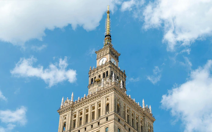 Palace of Culture and Science tower against blue sky, Warsaw, Poland.