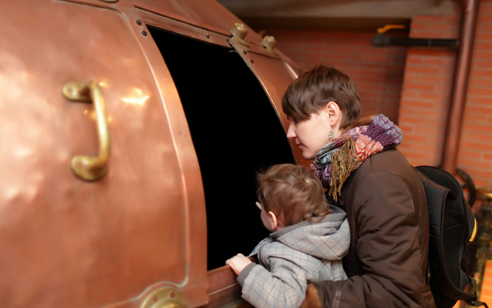 Visitors exploring exhibits at a Prague museum with historical artifacts and interactive displays.