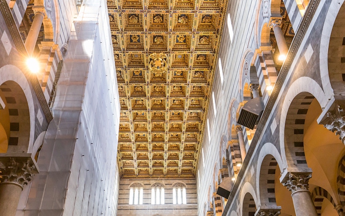 Pisa Cathedral interior with detailed gold roof murals and arches.