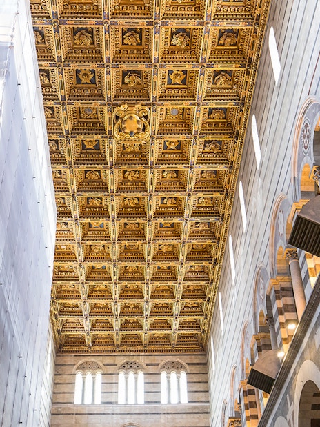 Pisa Cathedral interior with detailed gold roof murals and arches.