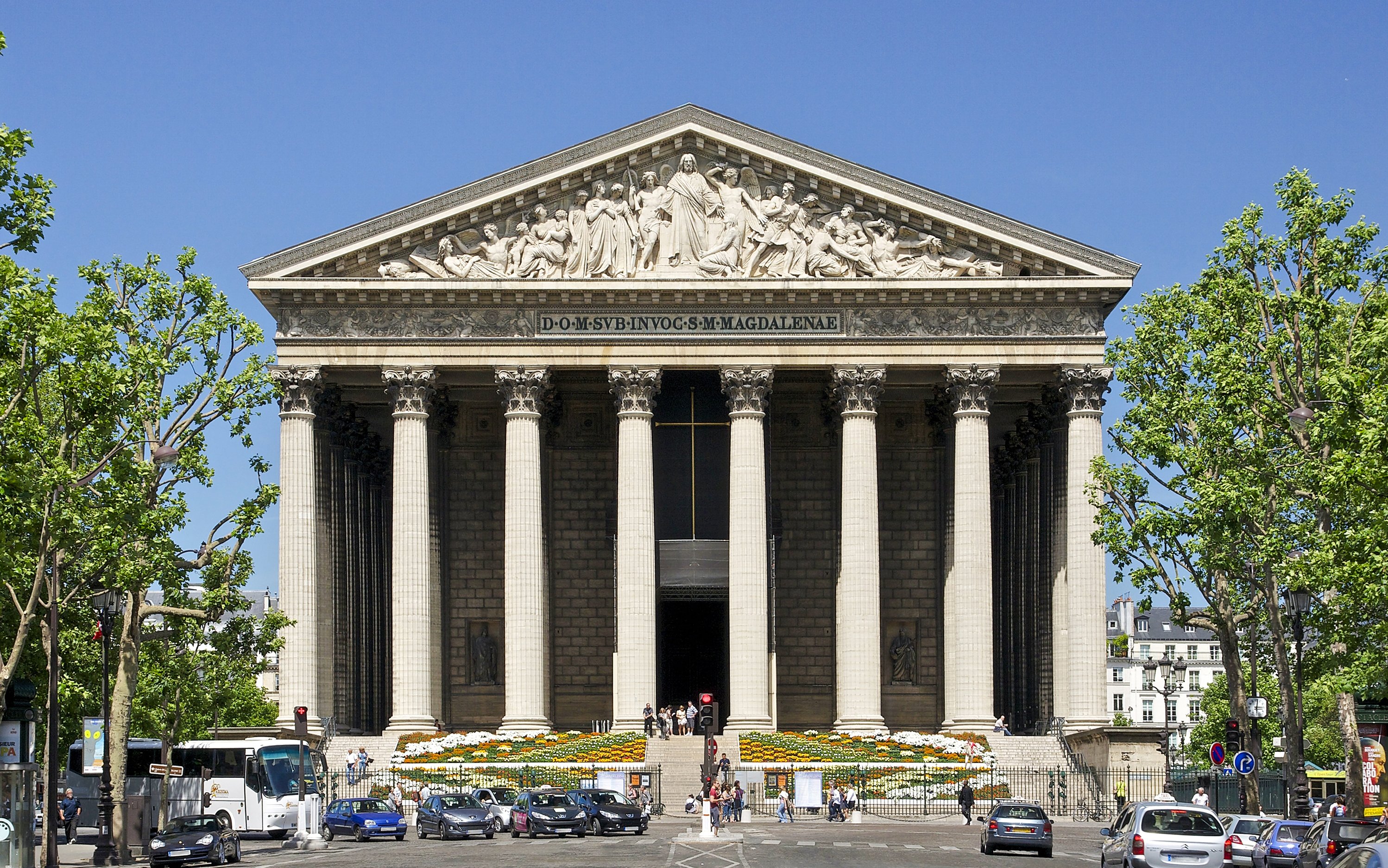 The Church of St Madeleine in Paris with neoclassical columns and sculptures.