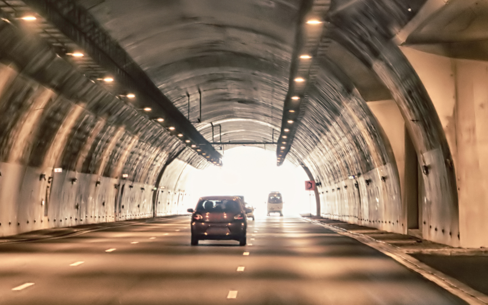 Cars driving through a mountain tunnel in Rio de Janeiro.
