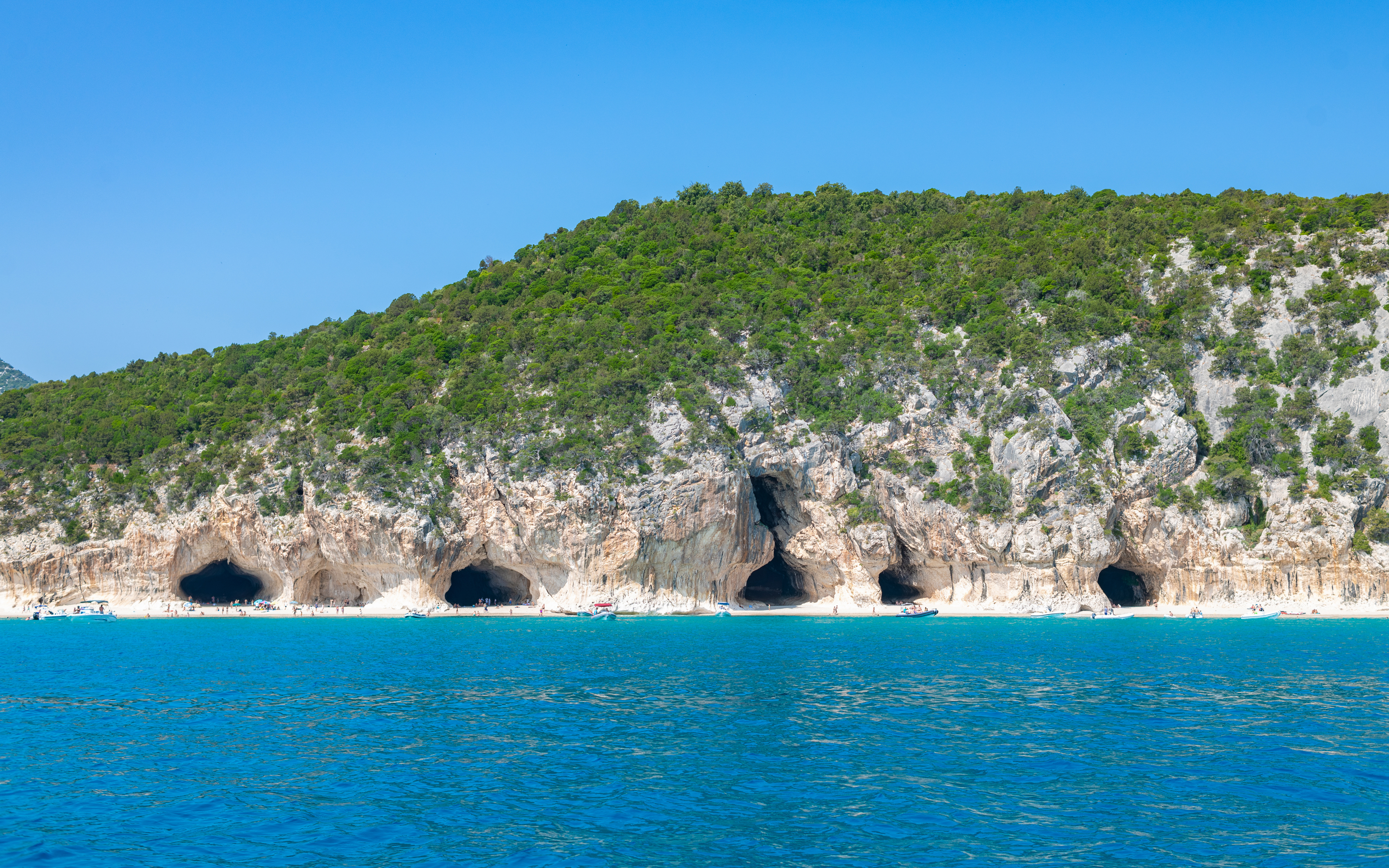 Caves and turquoise water at Cala Luna beach, Gulf of Orosei, Sardinia, Italy.