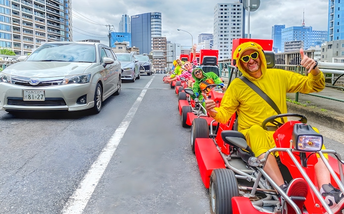 Participants in costumes enjoying street go-karting at Tokyo Bay.