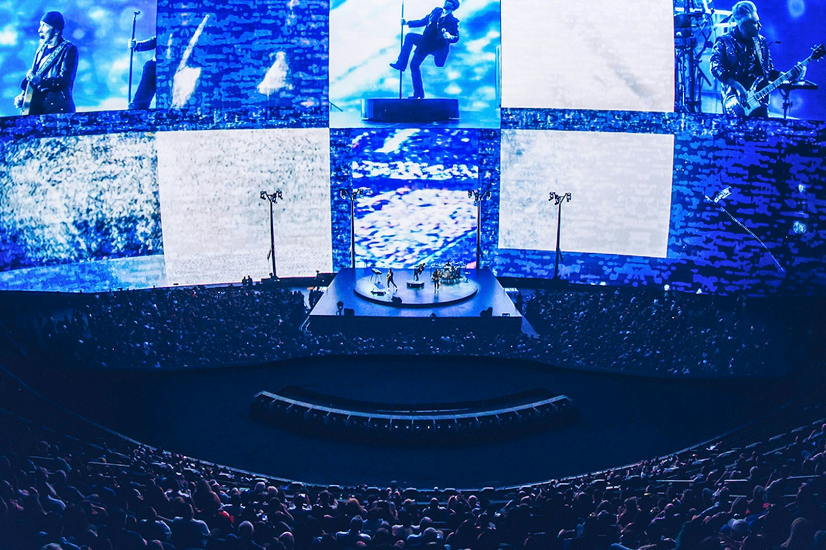 Concert at Sphere Las Vegas with band performing on stage, immersive visuals surrounding audience.