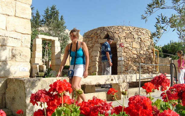 Visitors exploring stone structures and gardens at The Limestone Heritage Park.