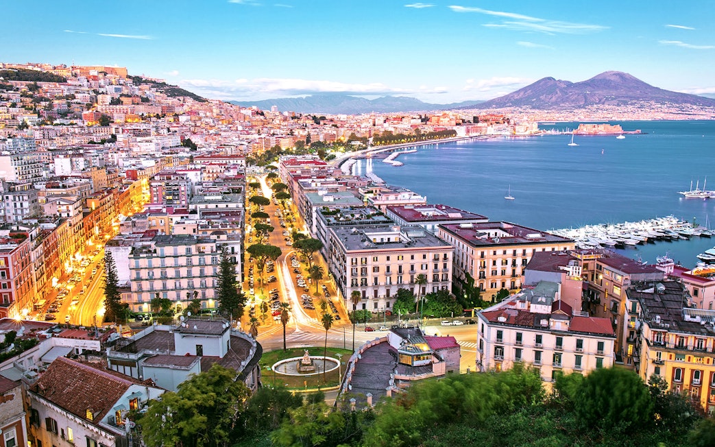 Naples cityscape with Mount Vesuvius and harbor, view from Porta Nolana area.