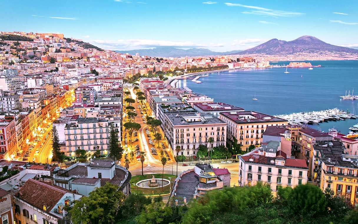 Naples cityscape with Mount Vesuvius and harbor, view from Porta Nolana area.
