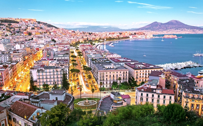 Naples cityscape with Mount Vesuvius and harbor, view from Porta Nolana area.