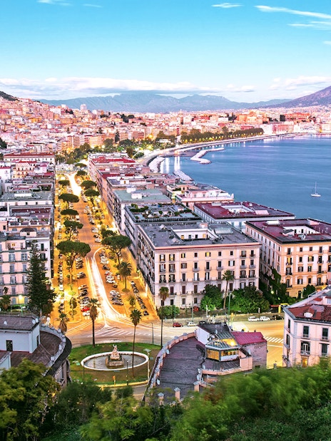 Naples cityscape with Mount Vesuvius and harbor, view from Porta Nolana area.