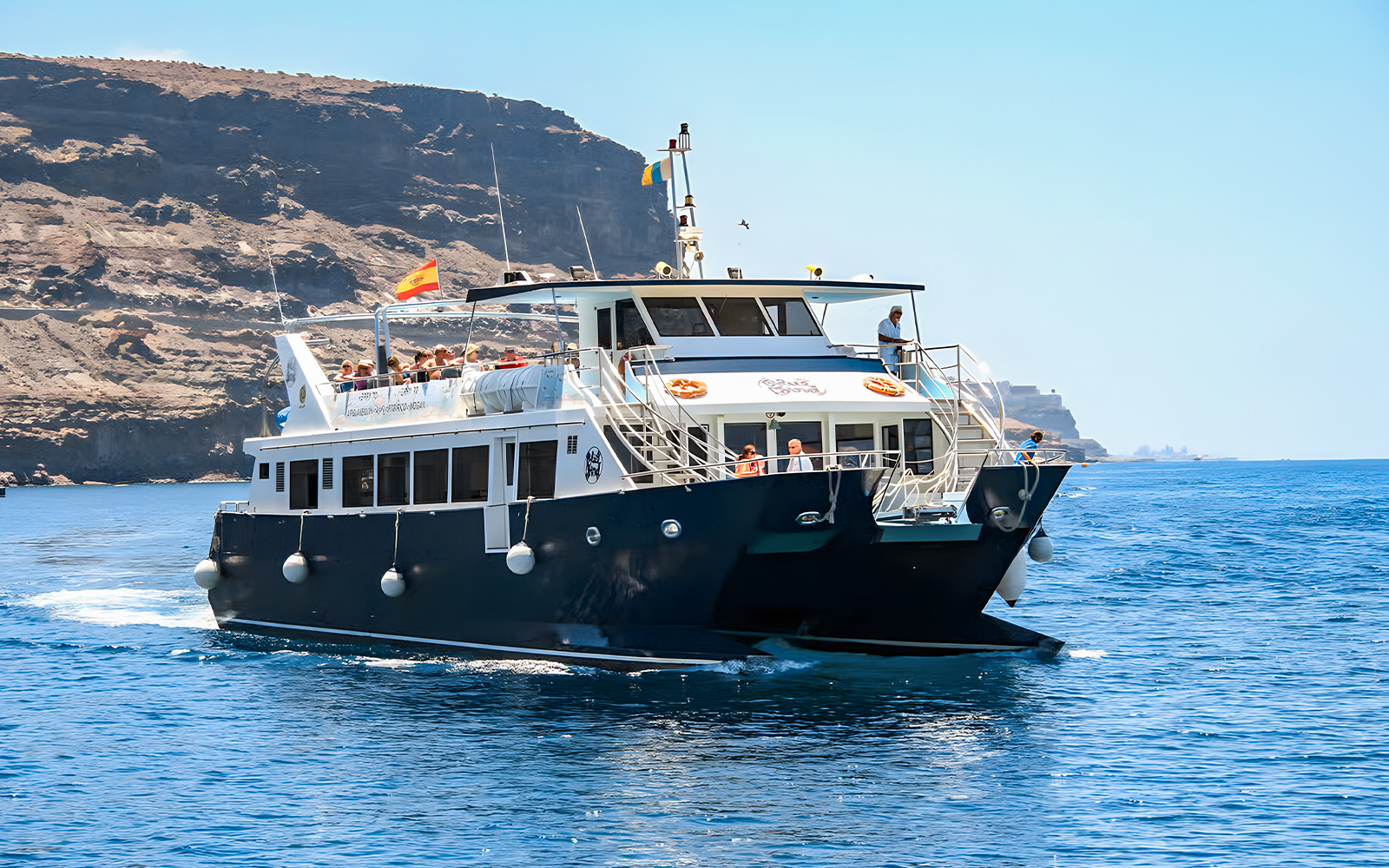 Gran Canaria cruise boat with tourists on dolphin watching experience.