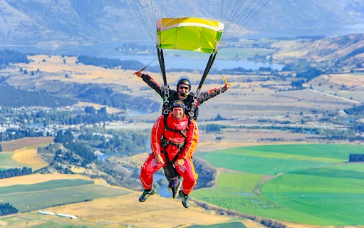 Tandem skydive over Wanaka with scenic landscape below.
