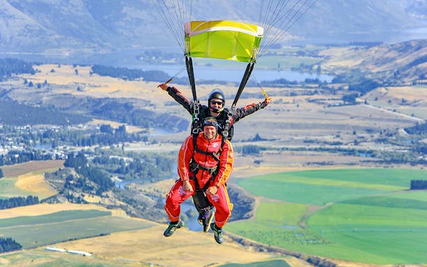 Tandem skydive over Wanaka with scenic landscape below.