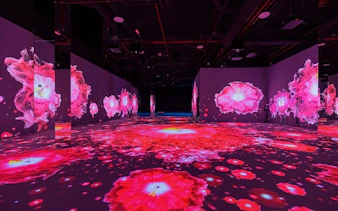 Immersive digital art installation with vibrant pink floral projections in Kuala Lumpur.