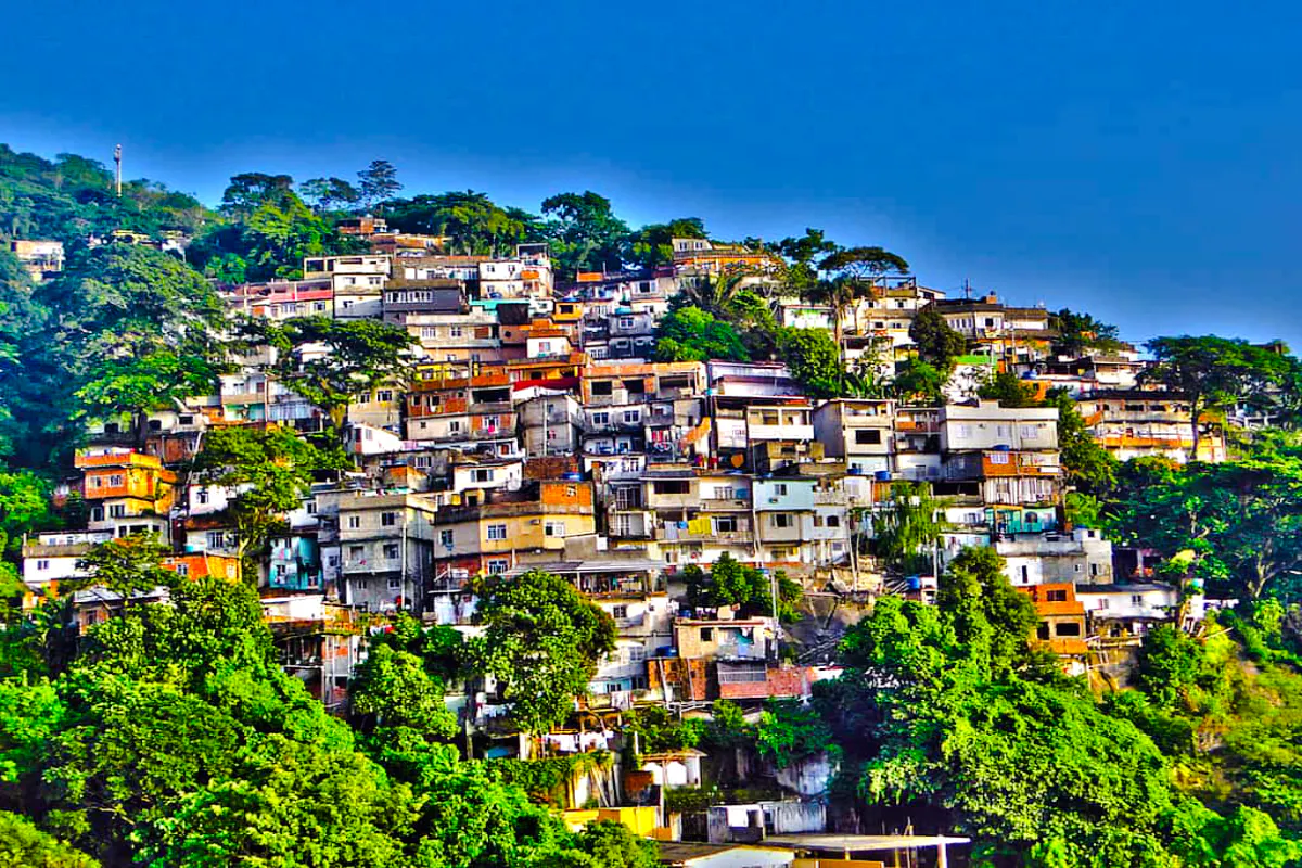 Rocinha Favela hillside view with colorful houses and lush greenery, Rio de Janeiro.