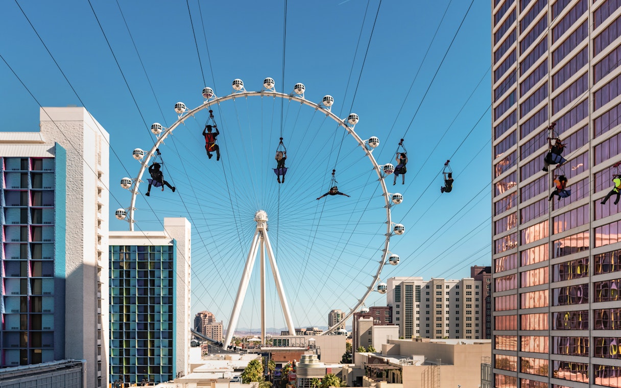 People ziplining near the High Roller Ferris wheel in Las Vegas.