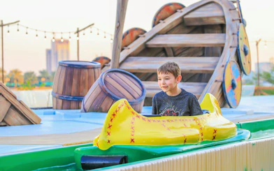 Child enjoying a water ride at Al Montazah Parks, Island of Legends.