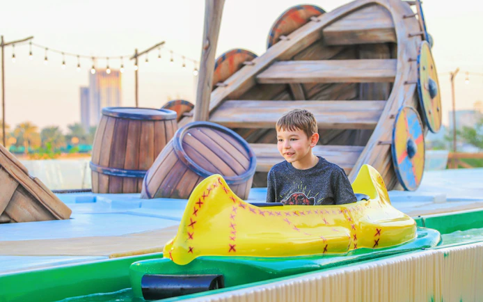 Child enjoying a water ride at Al Montazah Parks, Island of Legends.