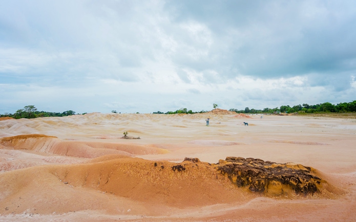 Bintan Mini Desert with sandy dunes under a cloudy sky, Indonesia.