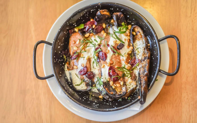 Gourmet dish with eggplant, pine nuts, and cranberries on a 3.5-hour art tour.