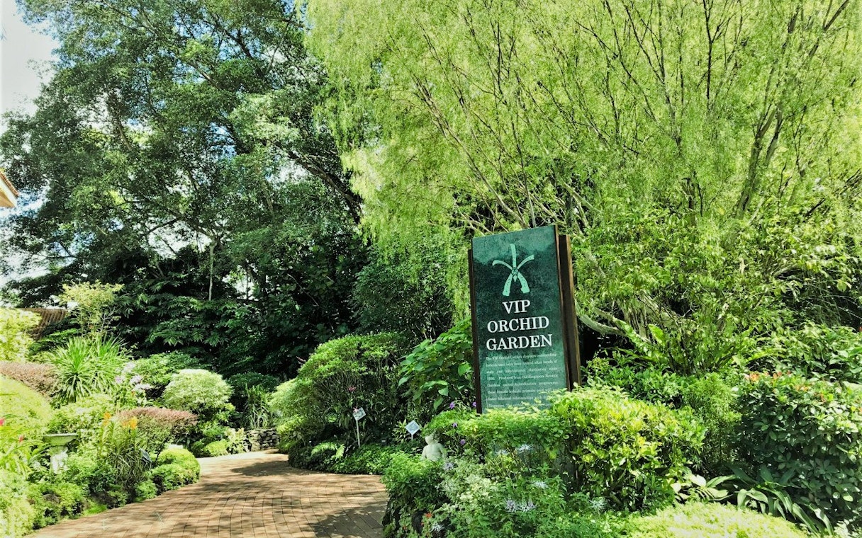 VIP Orchid Garden entrance surrounded by lush greenery at National Orchid Garden, Singapore.