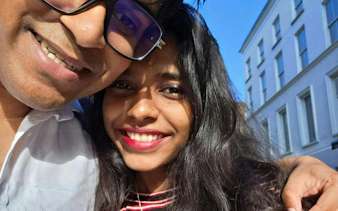 Selfie of two people smiling in front of a building in Dublin.