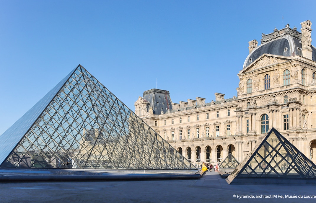 Louvre Museum glass pyramid entrance in Paris, France.
