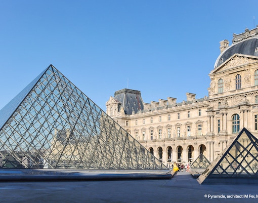 Louvre Museum glass pyramid entrance in Paris, France.