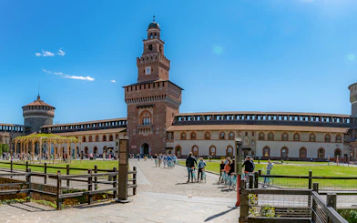 Sforza Castle courtyard with visitors, Milan, Italy.