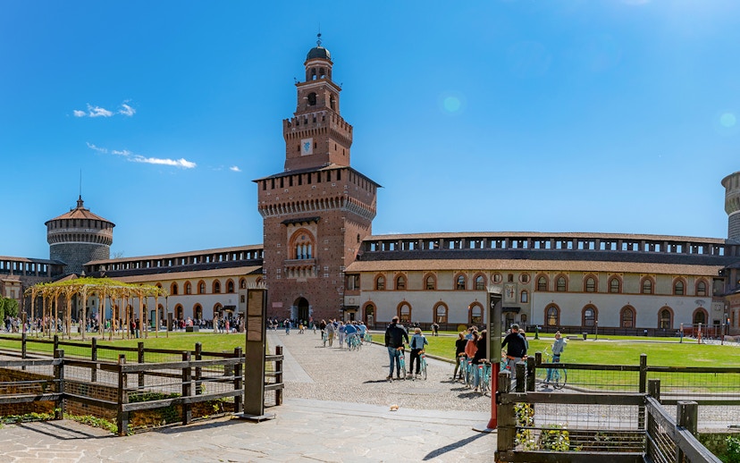 Sforza Castle courtyard with visitors, Milan, Italy.
