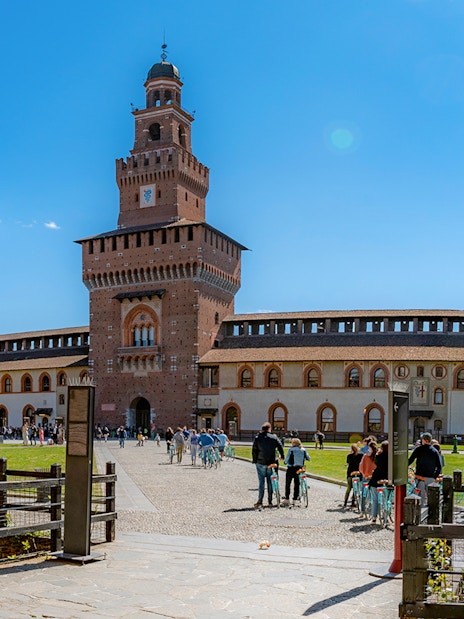 Sforza Castle courtyard with visitors, Milan, Italy.