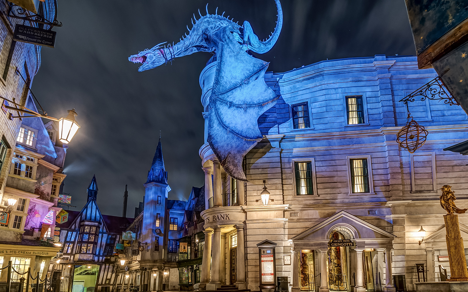 Gringotts Bank with dragon at Universal Orlando's Diagon Alley at night.