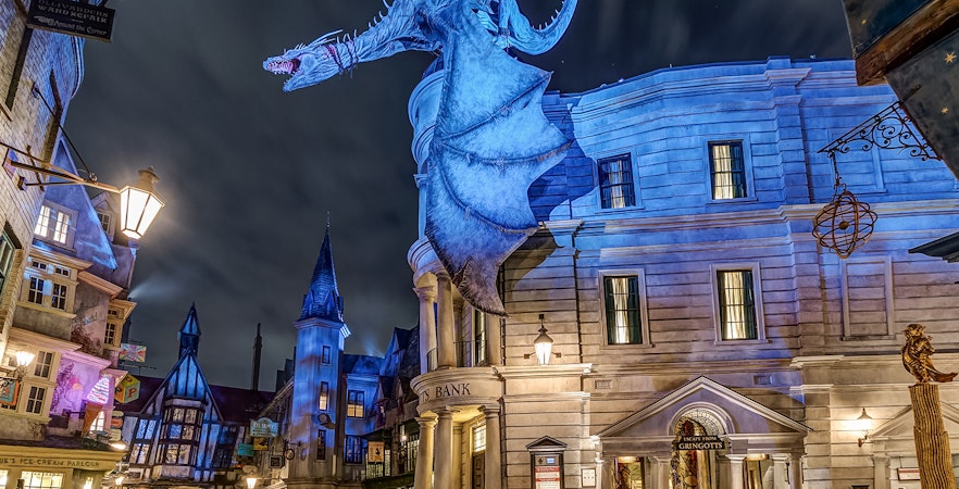 Gringotts Bank with dragon at Universal Orlando's Diagon Alley at night.