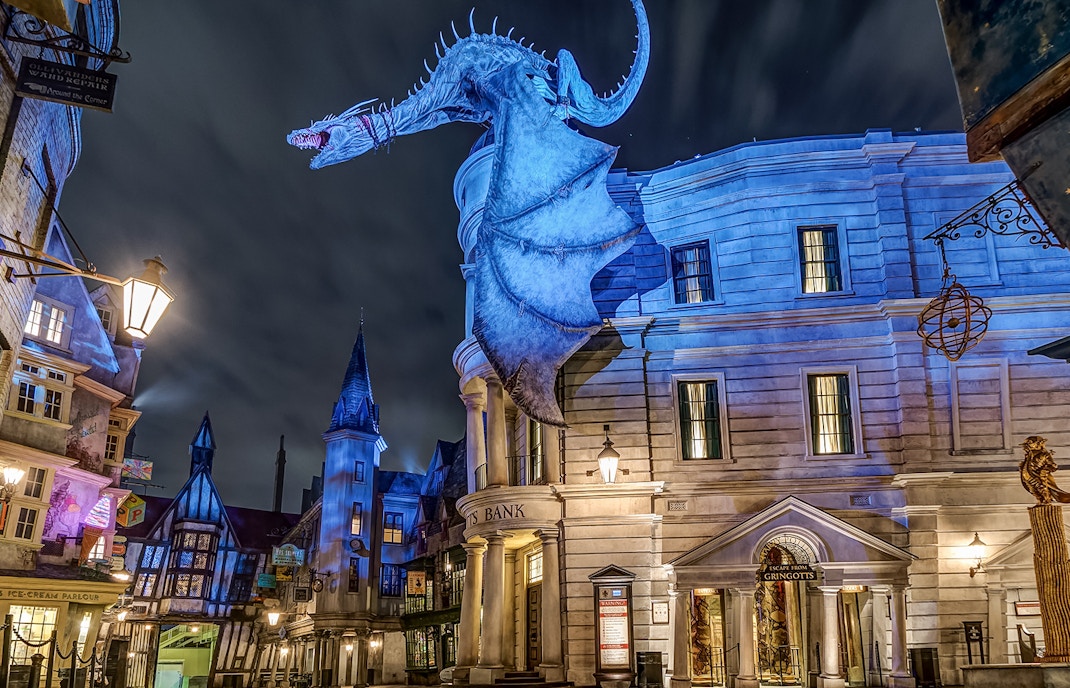 Gringotts Bank with dragon at Universal Orlando's Diagon Alley at night.