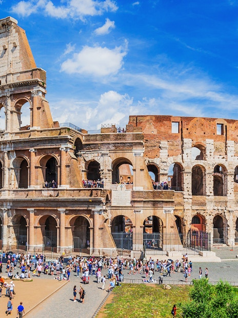 Colosseum in Rome with tourists exploring the ancient amphitheater.