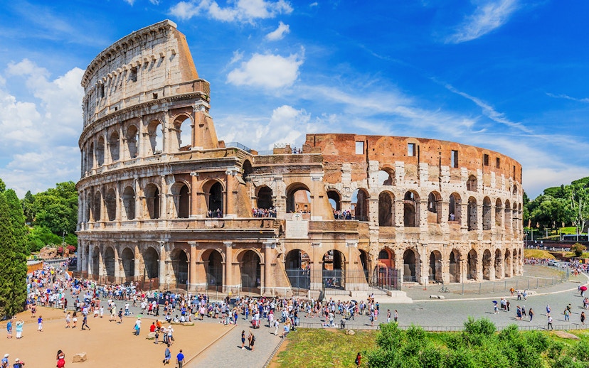 Colosseum in Rome with tourists exploring the ancient amphitheater.