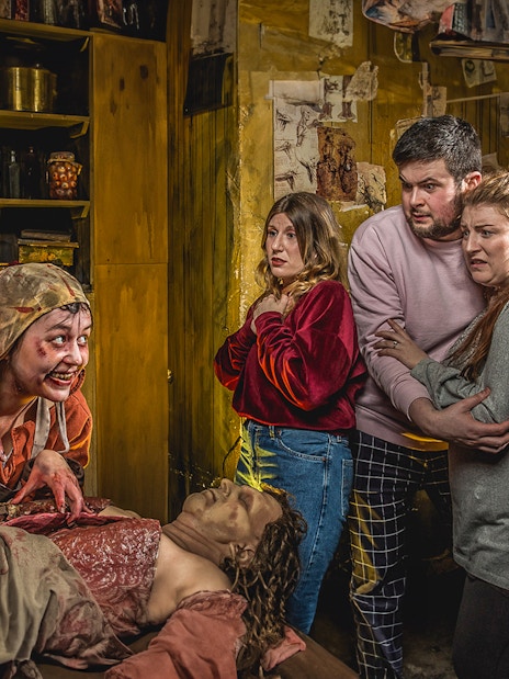 Group reacting to a performer in the Anatomy Theatre at the Edinburgh Dungeon.