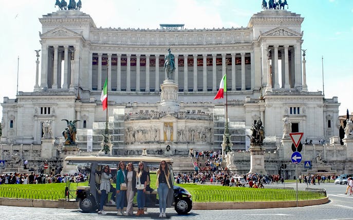 Golf cart tour group in front of the Altare della Patria, Rome.