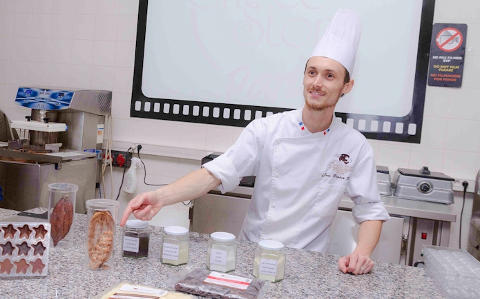 Chocolate chef demonstrating ingredients at Choco-Story Paris.