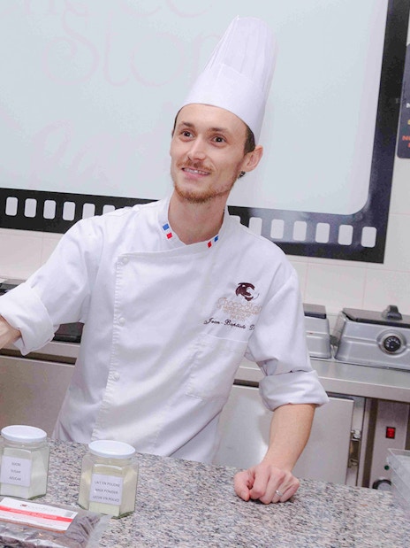 Chocolate chef demonstrating ingredients at Choco-Story Paris.